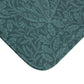 A rectangular microfibre bath mat in teal colour, featuring a floral pattern inspired by William Morris.