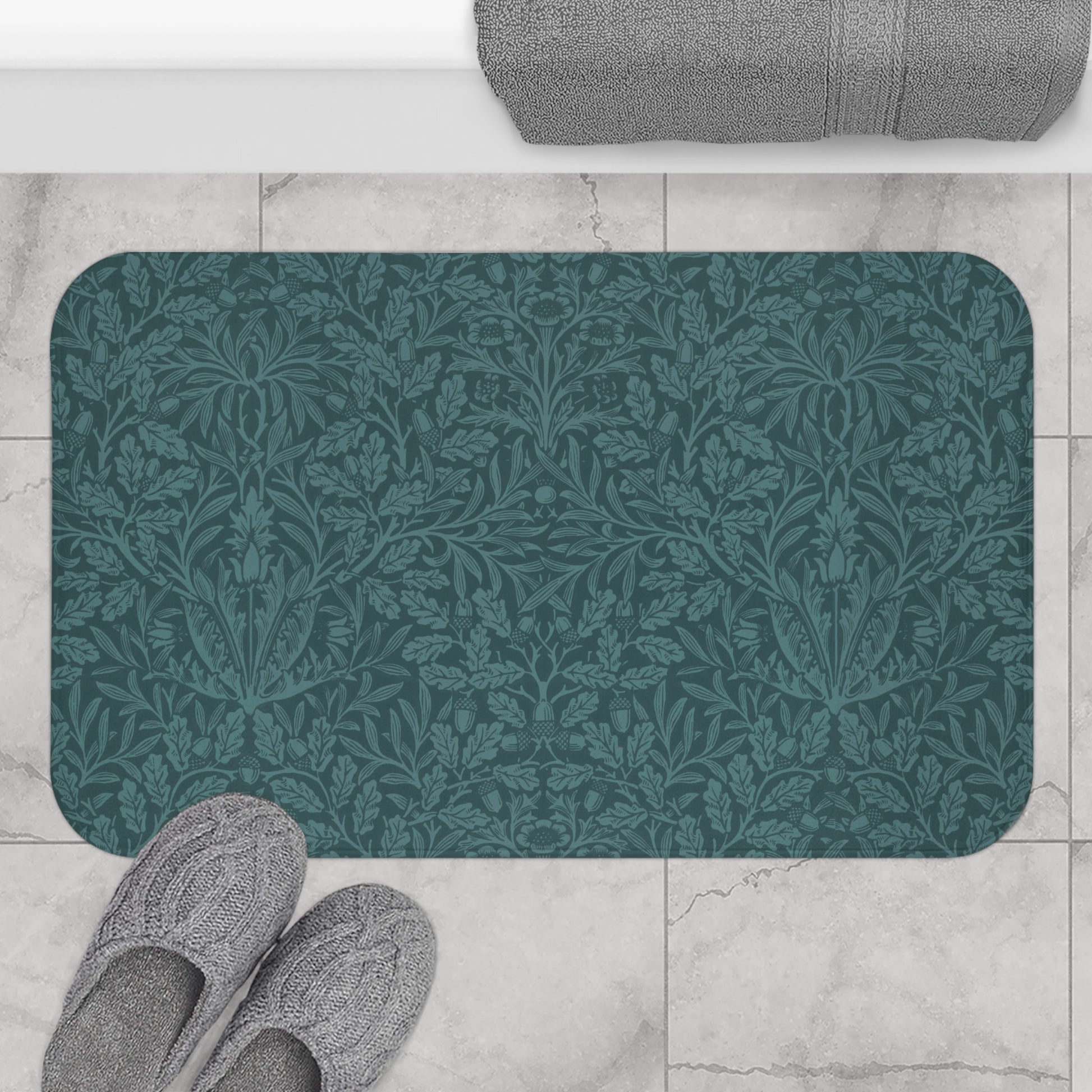 A rectangular microfibre bath mat in teal colour, featuring a floral pattern inspired by William Morris.