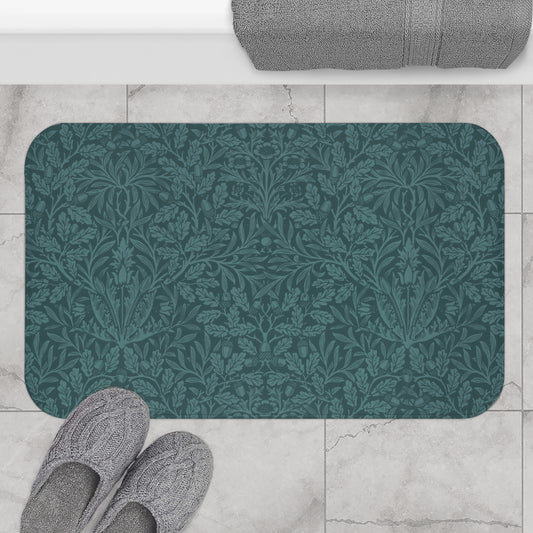 A rectangular microfibre bath mat in teal colour, featuring a floral pattern inspired by William Morris.