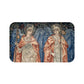 A microfibre bath mat with a printed design featuring two angels from the William Morris Angeli Ministrantes collection.