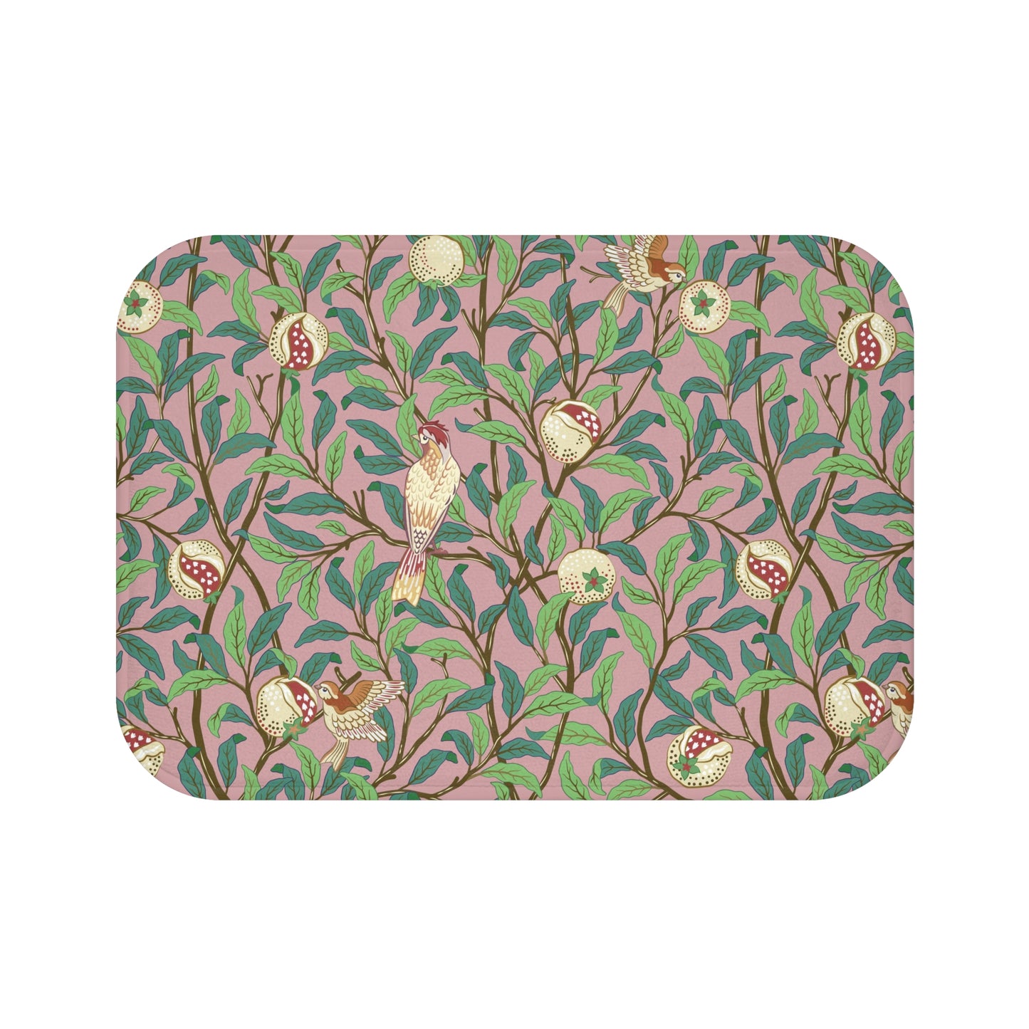 A rectangular microfibre bath mat with a William Morris floral pattern featuring birds and pomegranates in pink, green and white colours.