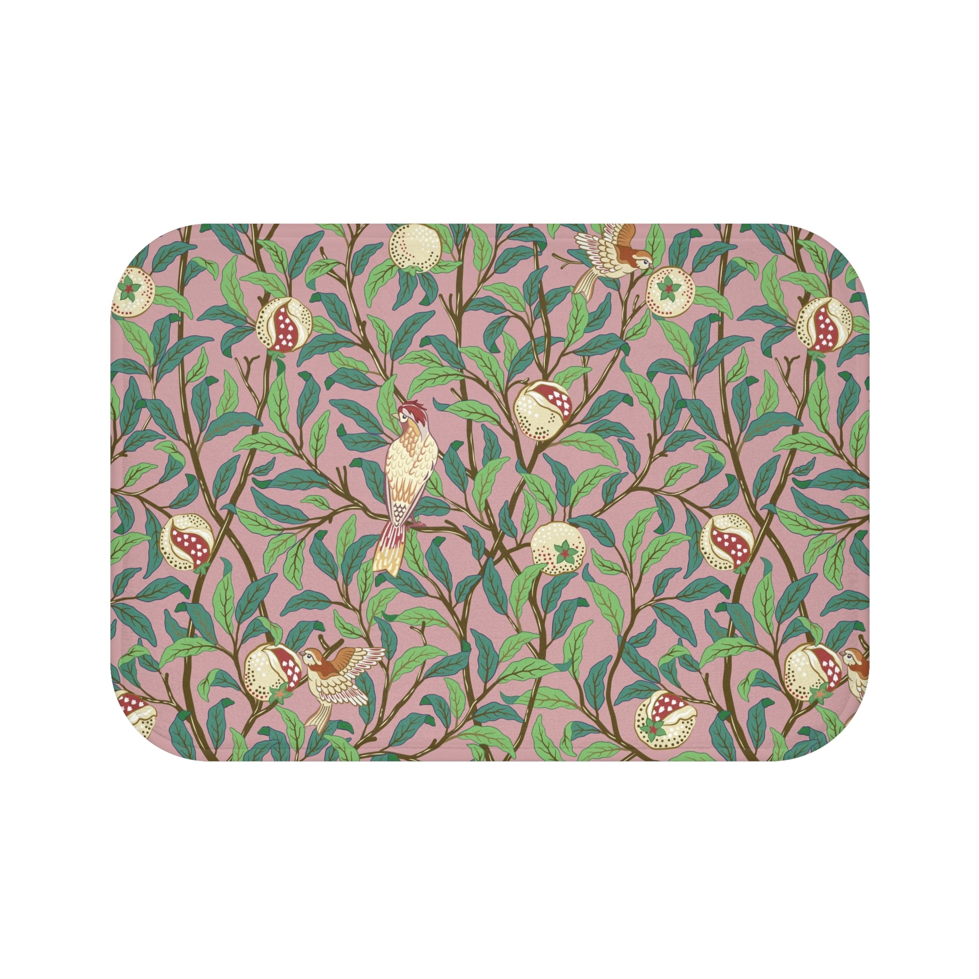 A rectangular microfibre bath mat with a William Morris floral pattern featuring birds and pomegranates in pink, green and white colours.