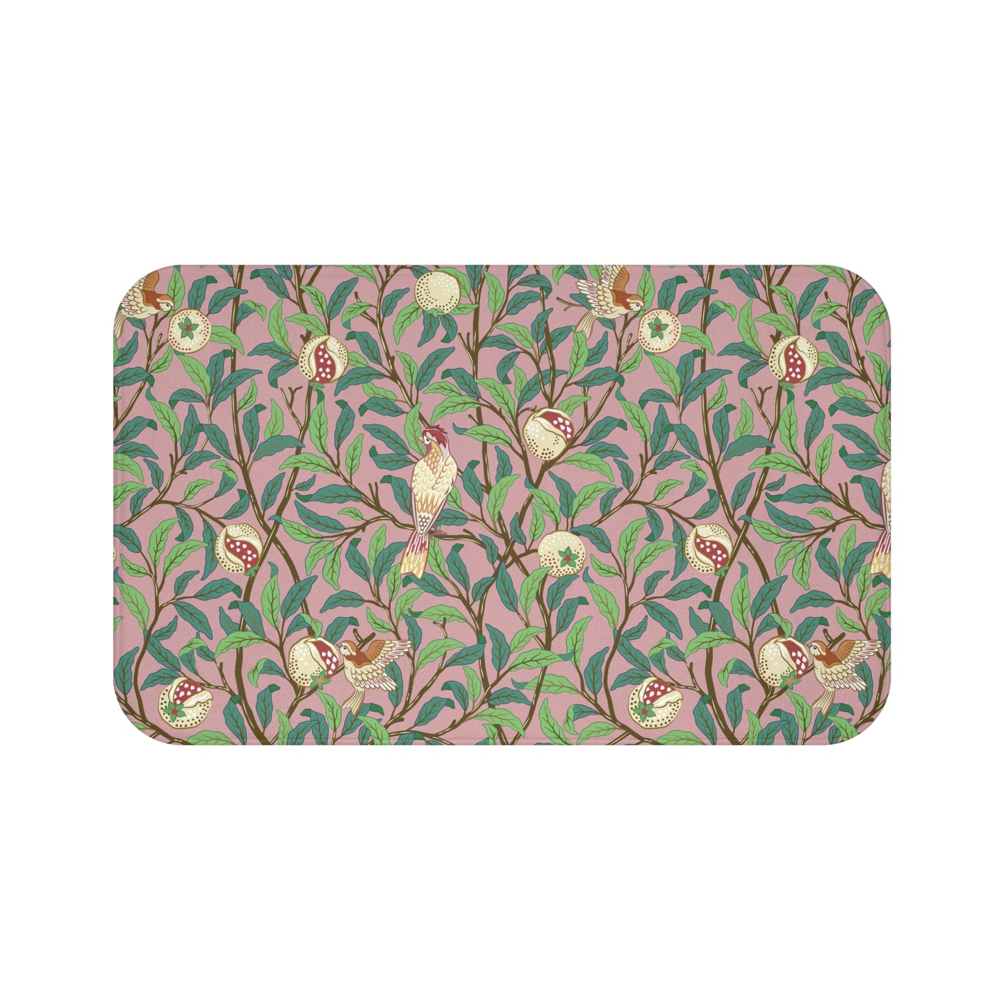 A rectangular microfibre bath mat with a William Morris floral pattern featuring birds and pomegranates in pink, green and white colours.