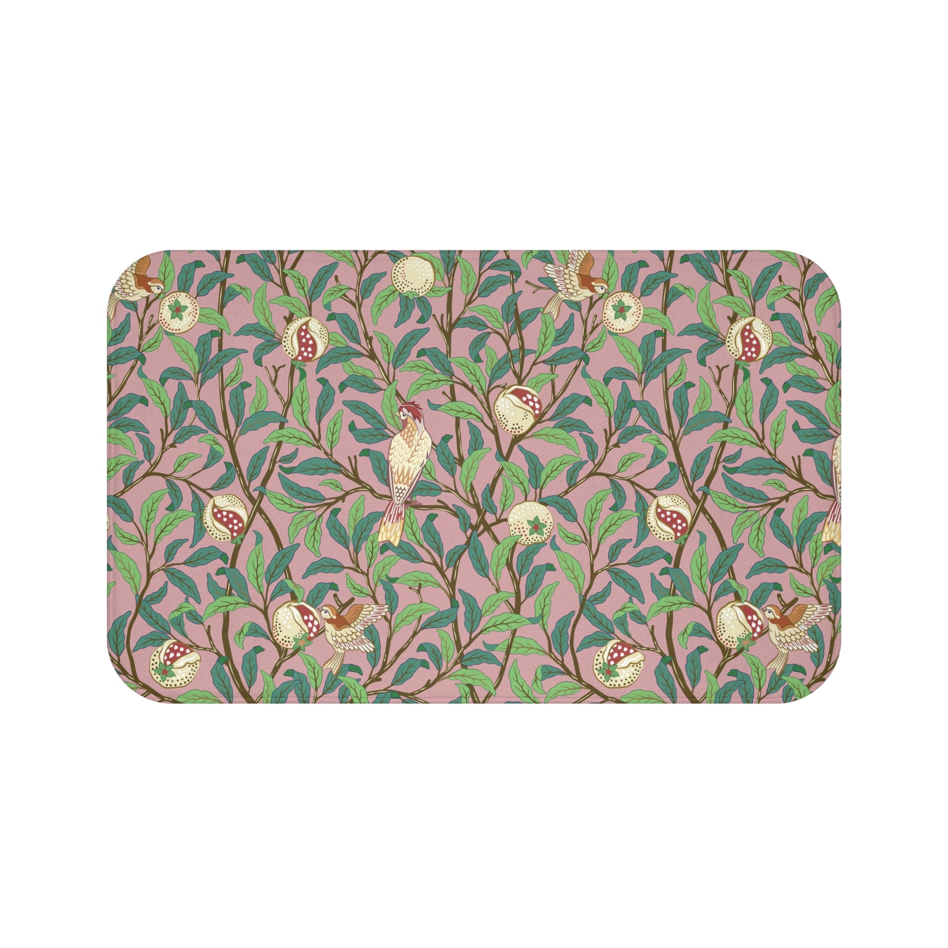 A rectangular microfibre bath mat with a William Morris floral pattern featuring birds and pomegranates in pink, green and white colours.