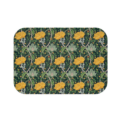 Microfibre bath mat with a floral pattern inspired by William Morris, predominantly yellow flowers on a green background with a non-slip border.