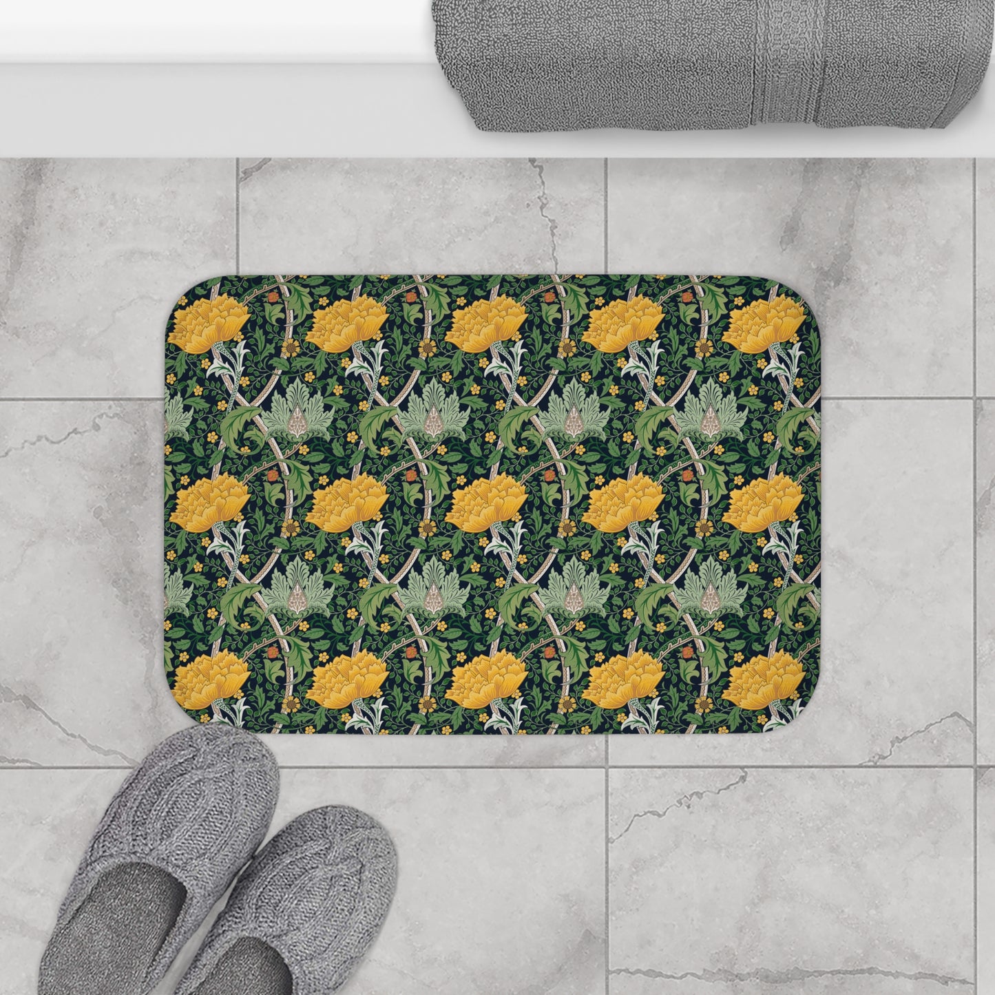 Microfibre bath mat with a floral pattern inspired by William Morris, predominantly yellow flowers on a green background with a non-slip border.