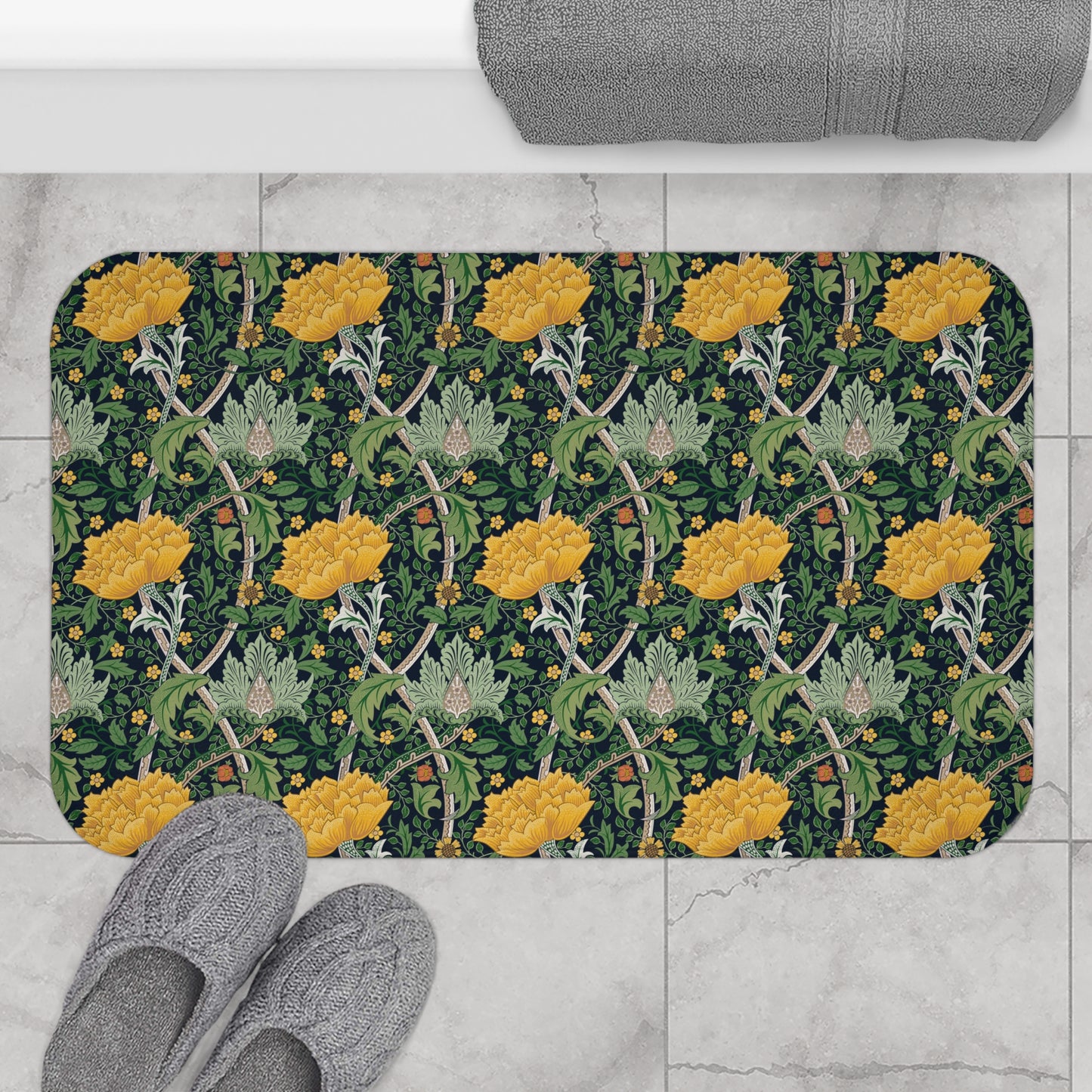 Microfibre bath mat with a floral pattern inspired by William Morris, predominantly yellow flowers on a green background with a non-slip border.