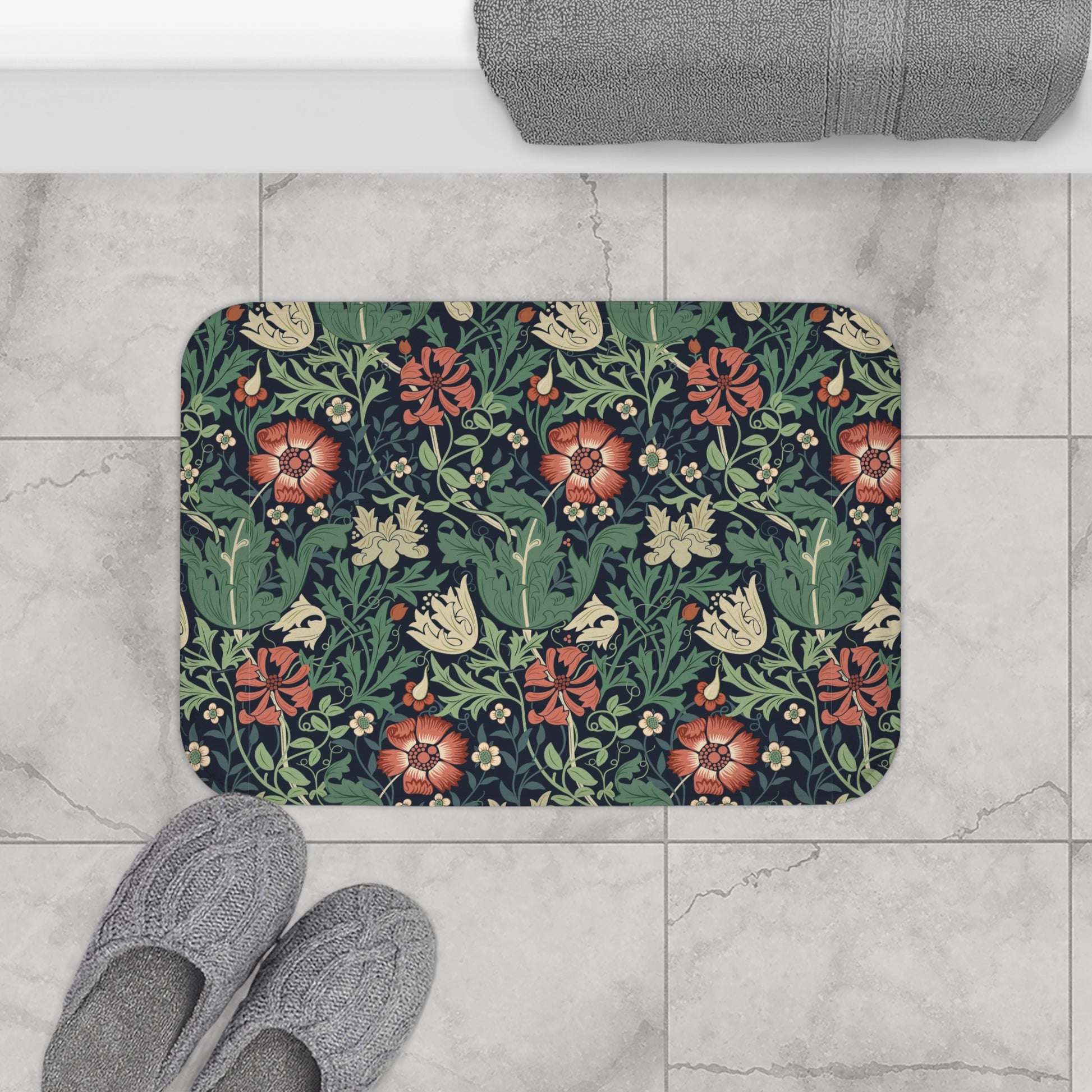 Rectangular microfibre bath mat with a floral pattern inspired by William Morris, in colours green, red, and beige.
