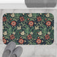 Rectangular microfibre bath mat with a floral pattern inspired by William Morris, in colours green, red, and beige.