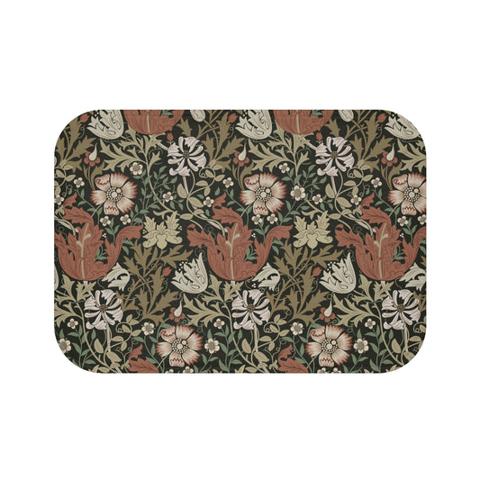 A rectangular microfibre bath mat with a floral pattern inspired by William Morris, in colours brown, beige, and green.