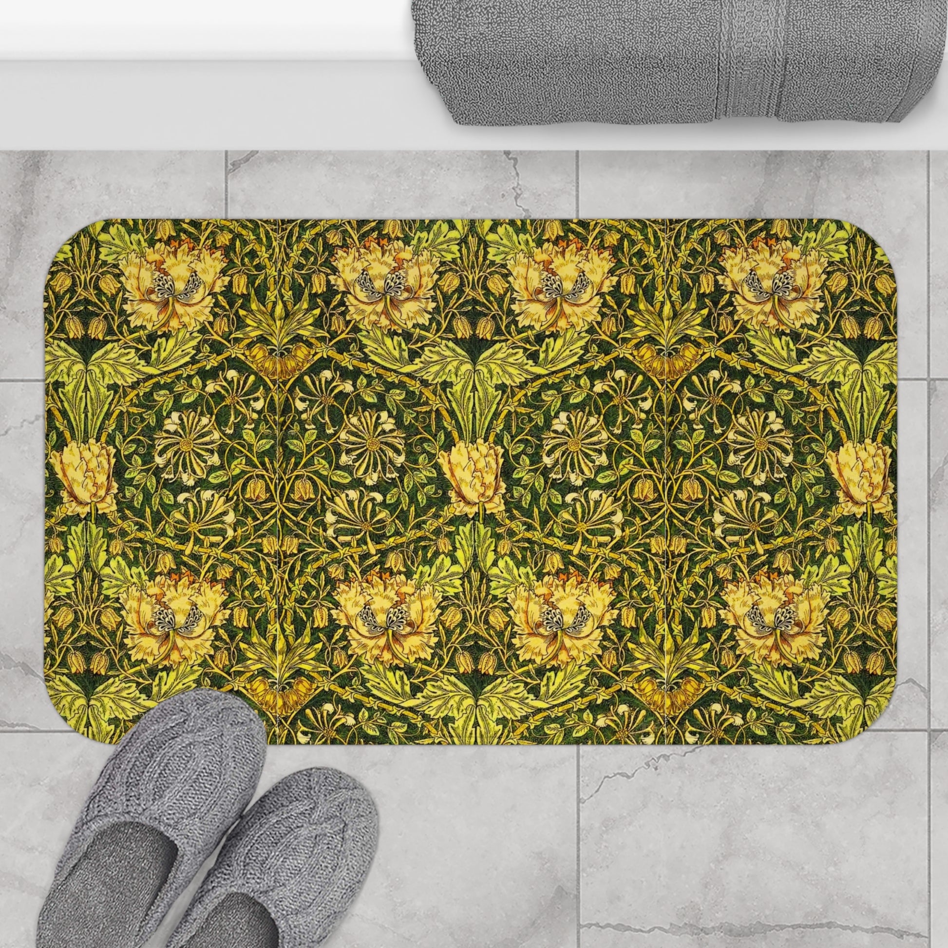 A round microfibre bath mat with a floral pattern in gold, brown, and green colours, inspired by William Morris - Honeysuckle Collection.