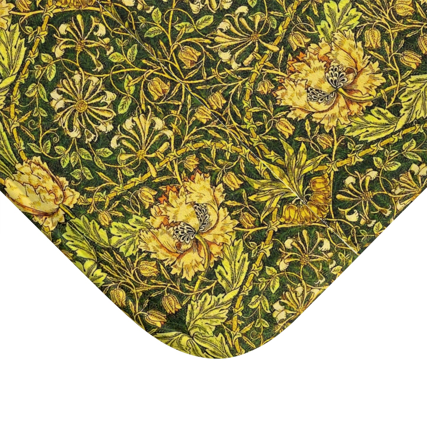 A round microfibre bath mat with a floral pattern in gold, brown, and green colours, inspired by William Morris - Honeysuckle Collection.