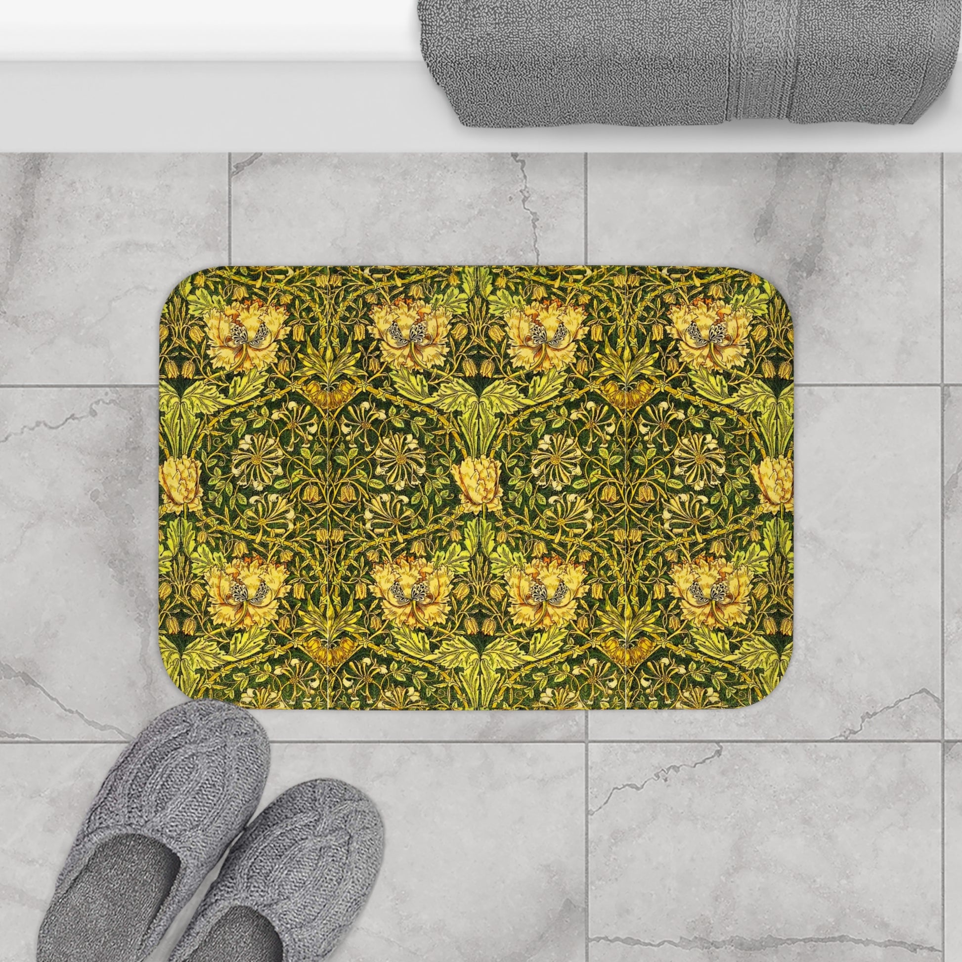 A round microfibre bath mat with a floral pattern in gold, brown, and green colours, inspired by William Morris - Honeysuckle Collection.