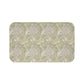Patterned green and beige rug on a white background