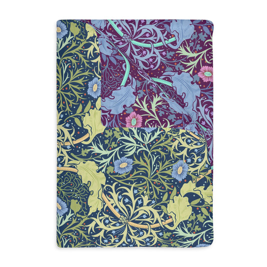 A Luxury Velveteen Minky Blanket with a two-sided print featuring a seaweed-inspired William Morris & Co floral pattern in blue, green and yellow tones.