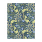 A Luxury Velveteen Minky Blanket with a two-sided print featuring a seaweed-inspired William Morris & Co floral pattern in blue, green and yellow tones.