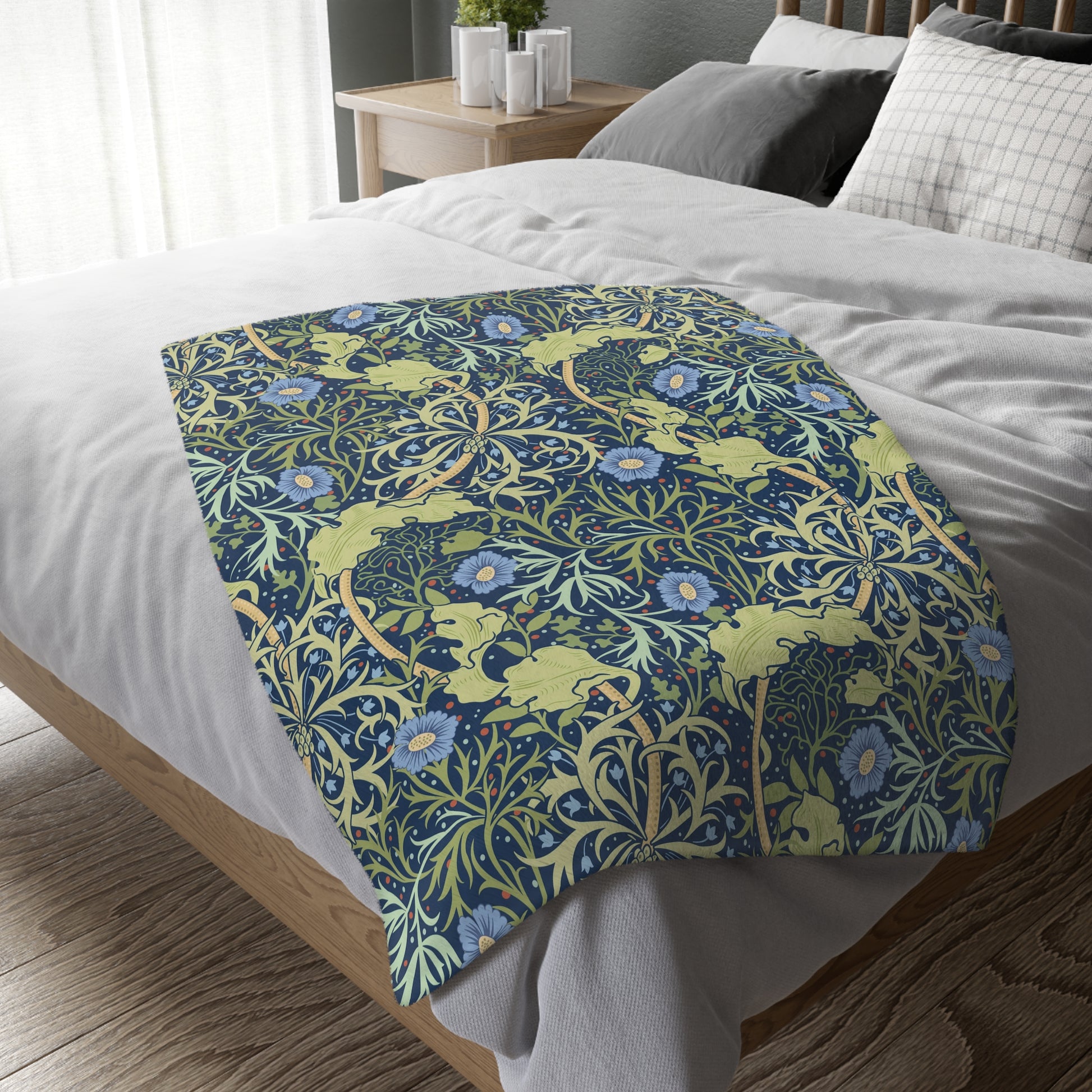 A Luxury Velveteen Minky Blanket with a two-sided print featuring a seaweed-inspired William Morris & Co floral pattern in blue, green and yellow tones.