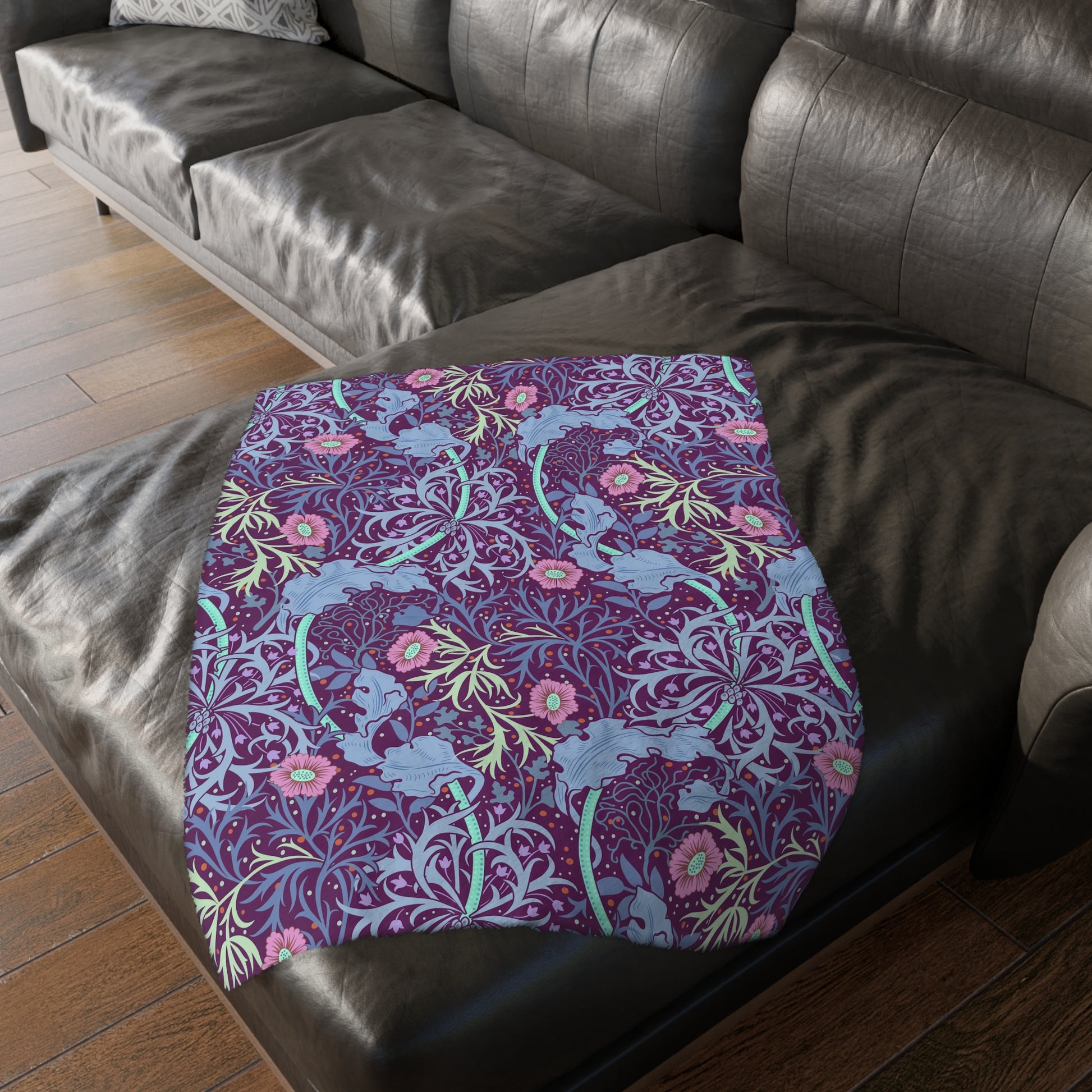 A Luxury Velveteen Minky Blanket with a two-sided print featuring a seaweed-inspired William Morris & Co floral pattern in blue, pink and purple tones.