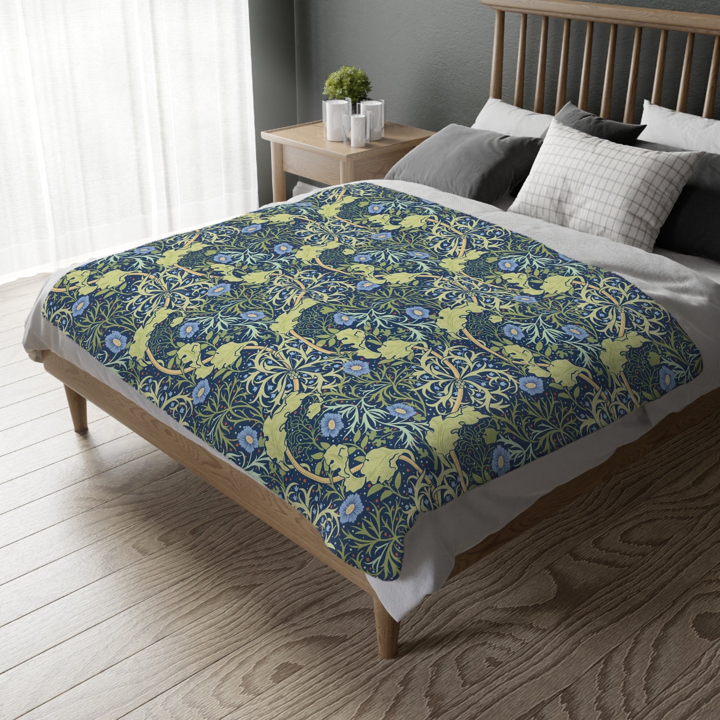 A Luxury Velveteen Minky Blanket with a two-sided print featuring a seaweed-inspired William Morris & Co floral pattern in blue, green and yellow tones.