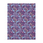 A Luxury Velveteen Minky Blanket with a two-sided print featuring a seaweed-inspired William Morris & Co floral pattern in blue, pink and purple tones.
