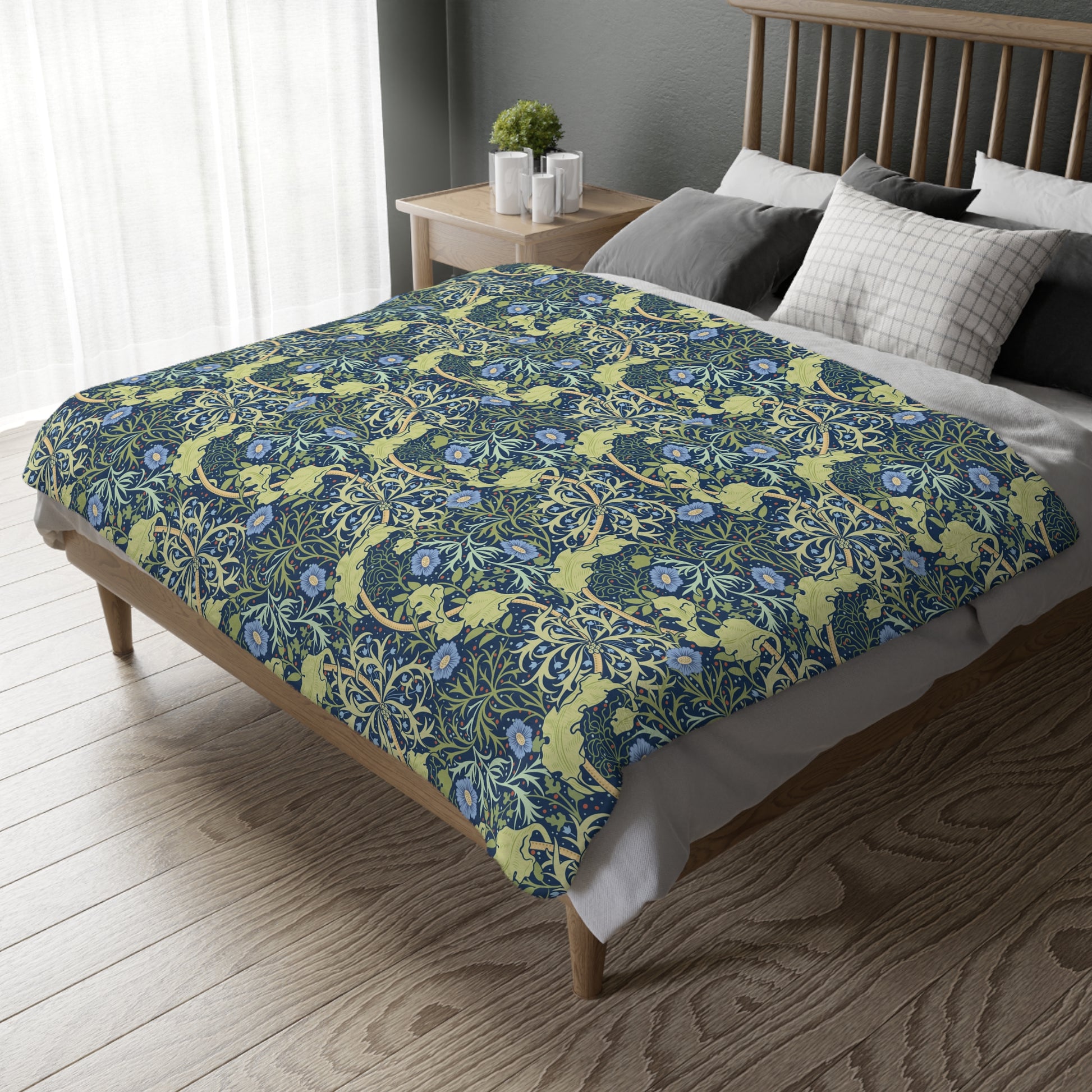 A Luxury Velveteen Minky Blanket with a two-sided print featuring a seaweed-inspired William Morris & Co floral pattern in blue, green and yellow tones.