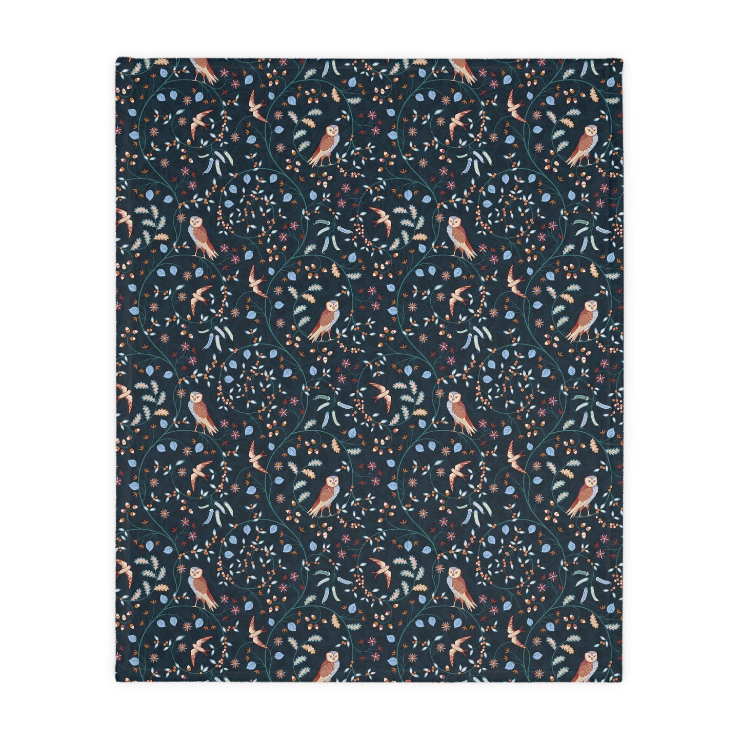 Patterned William Morris & Co blanket with birds and leaves on a dark blue background