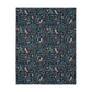 Patterned William Morris & Co blanket with birds and leaves on a dark blue background