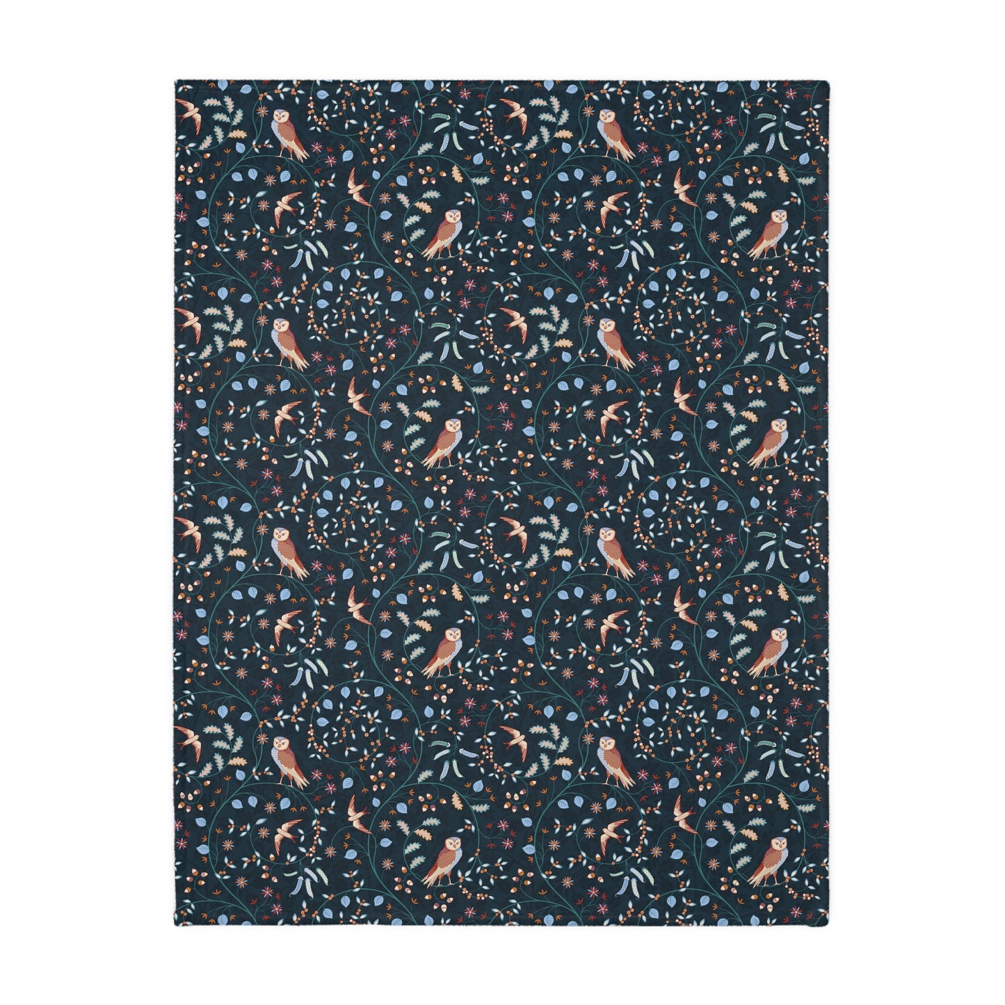 Patterned William Morris & Co blanket with birds and leaves on a dark blue background