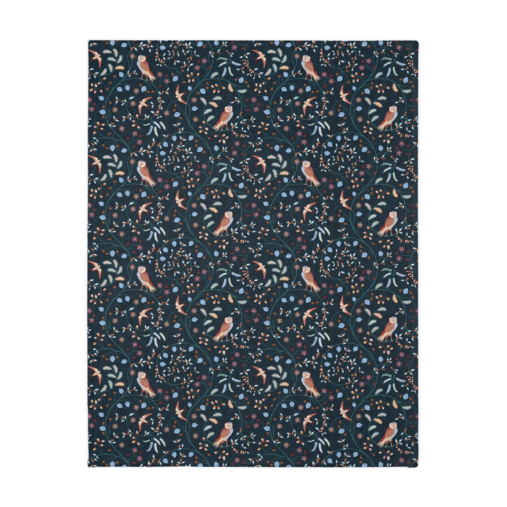Patterned William Morris & Co blanket with birds and leaves on a dark blue background