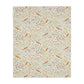 Patterned William Morris & Co blanket with birds and flowers on a white background