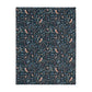 Patterned William Morris & Co blanket with birds and leaves on a dark blue background