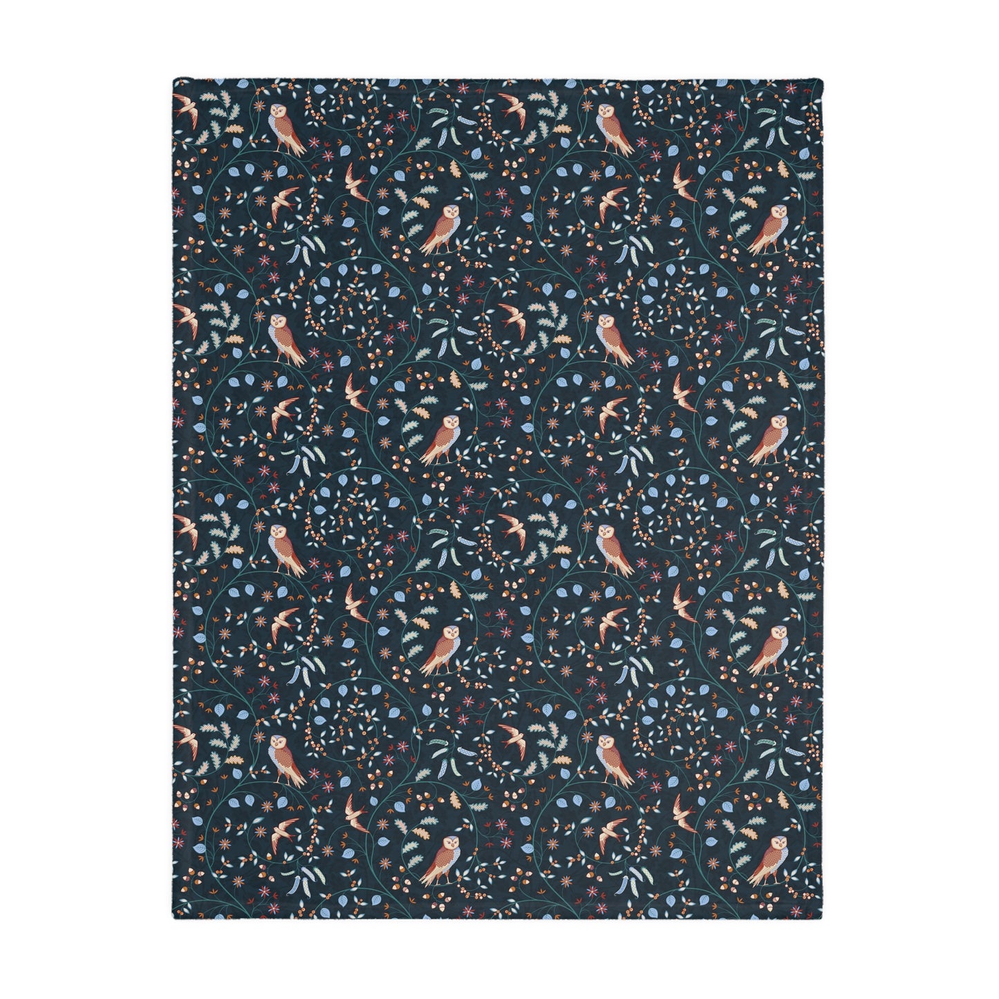 Patterned William Morris & Co blanket with birds and leaves on a dark blue background