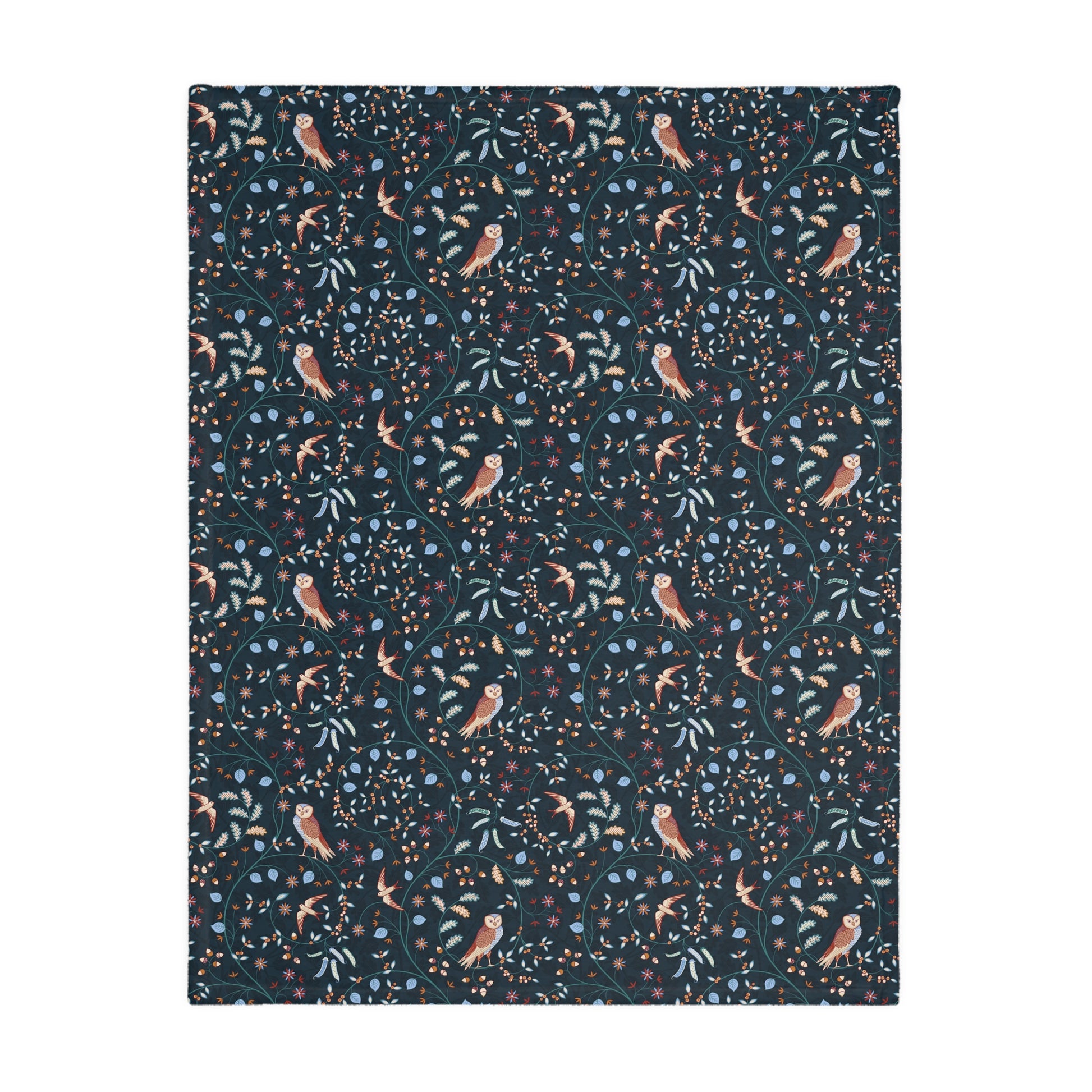 Patterned William Morris & Co blanket with birds and leaves on a dark blue background