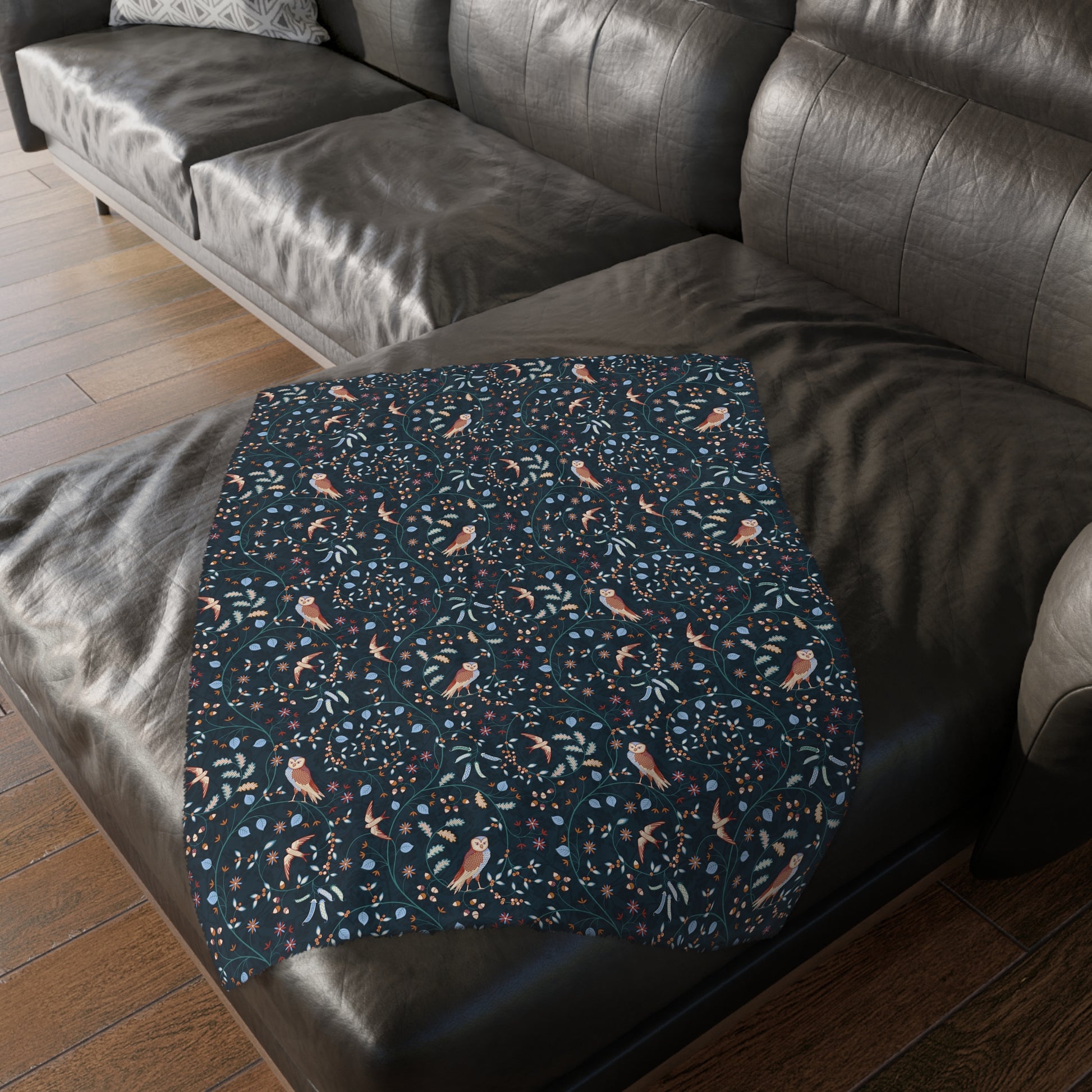 Patterned blanket on a dark brown leather sofa