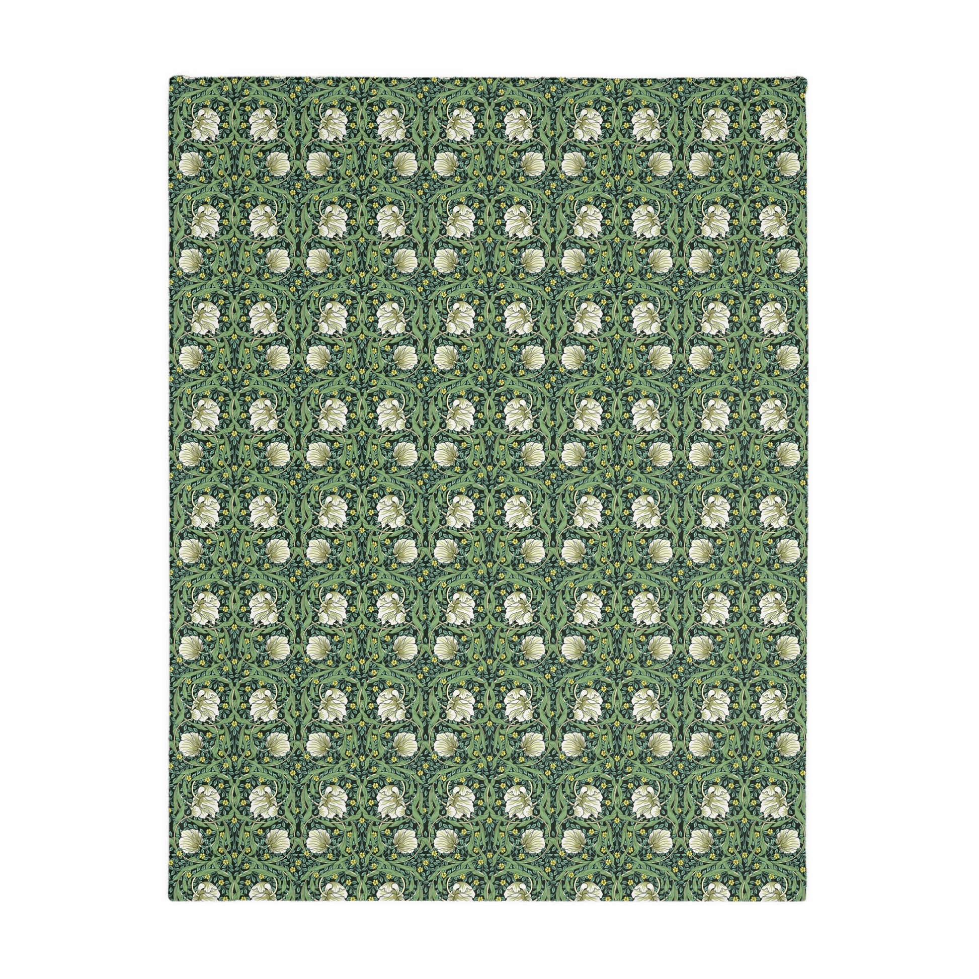 A rectangular blanket with a two-sided print featuring William Morris & Co floral patterns in shades of slate and green in a pattern called Pimpernel with a luxurious velveteen texture.