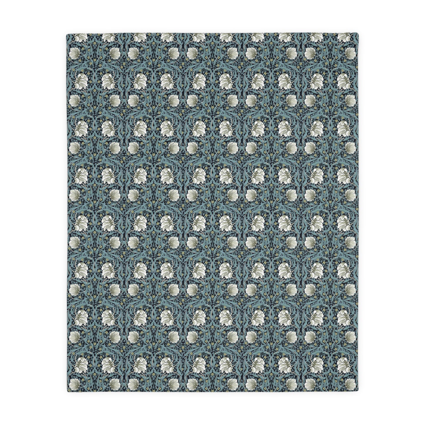 A rectangular blanket with a two-sided print featuring William Morris & Co floral patterns in shades of slate and green in a pattern called Pimpernel with a luxurious velveteen texture.