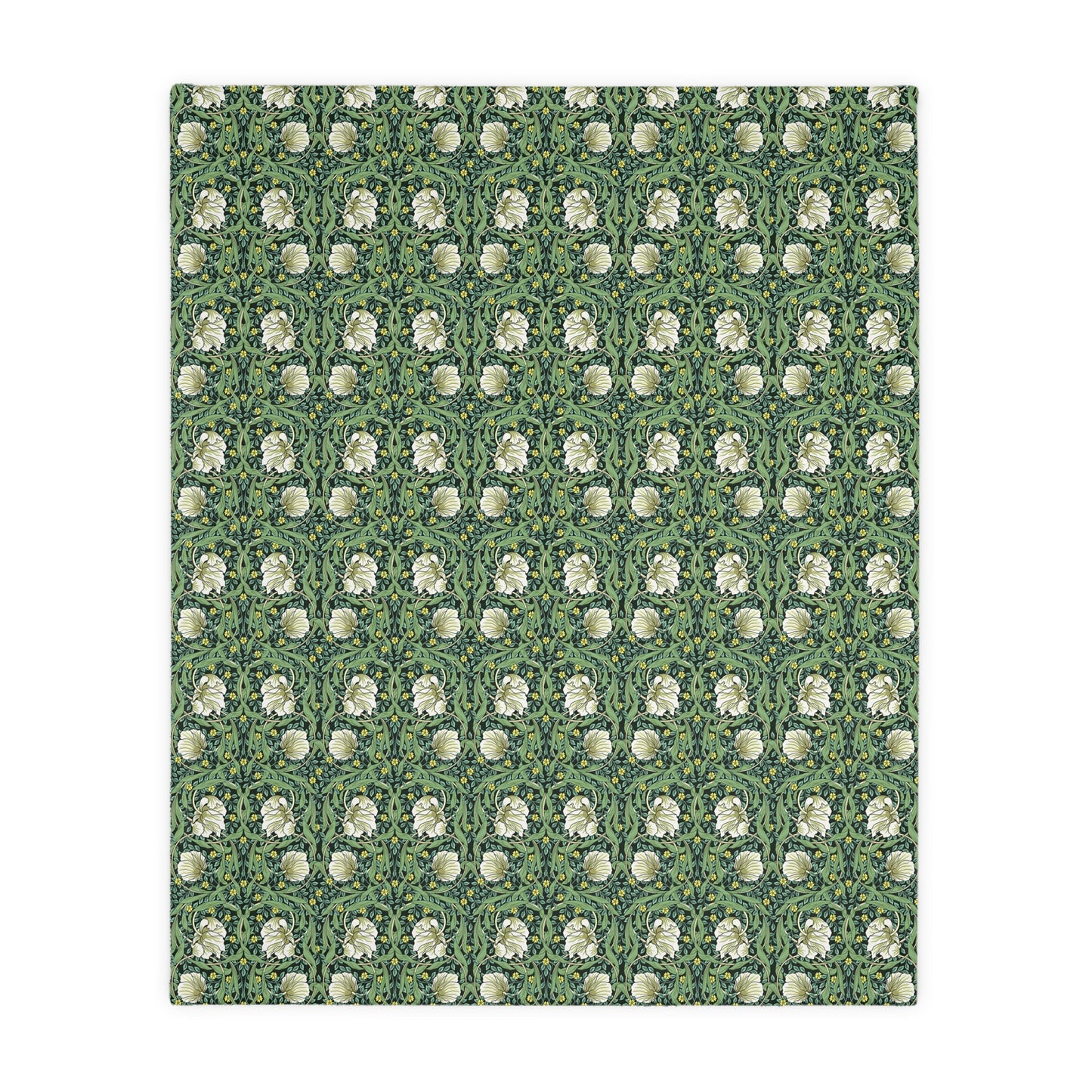 A rectangular blanket with a two-sided print featuring William Morris & Co floral patterns in shades of slate and green in a pattern called Pimpernel with a luxurious velveteen texture.