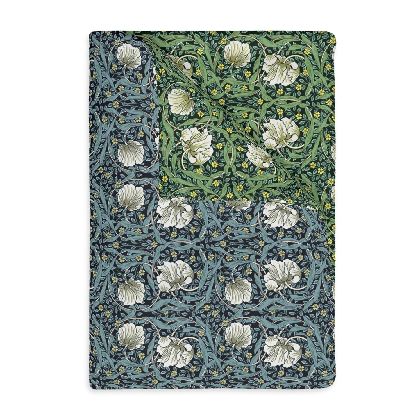 A rectangular blanket with a two-sided print featuring William Morris & Co floral patterns in shades of slate and green in a pattern called Pimpernel with a luxurious velveteen texture.