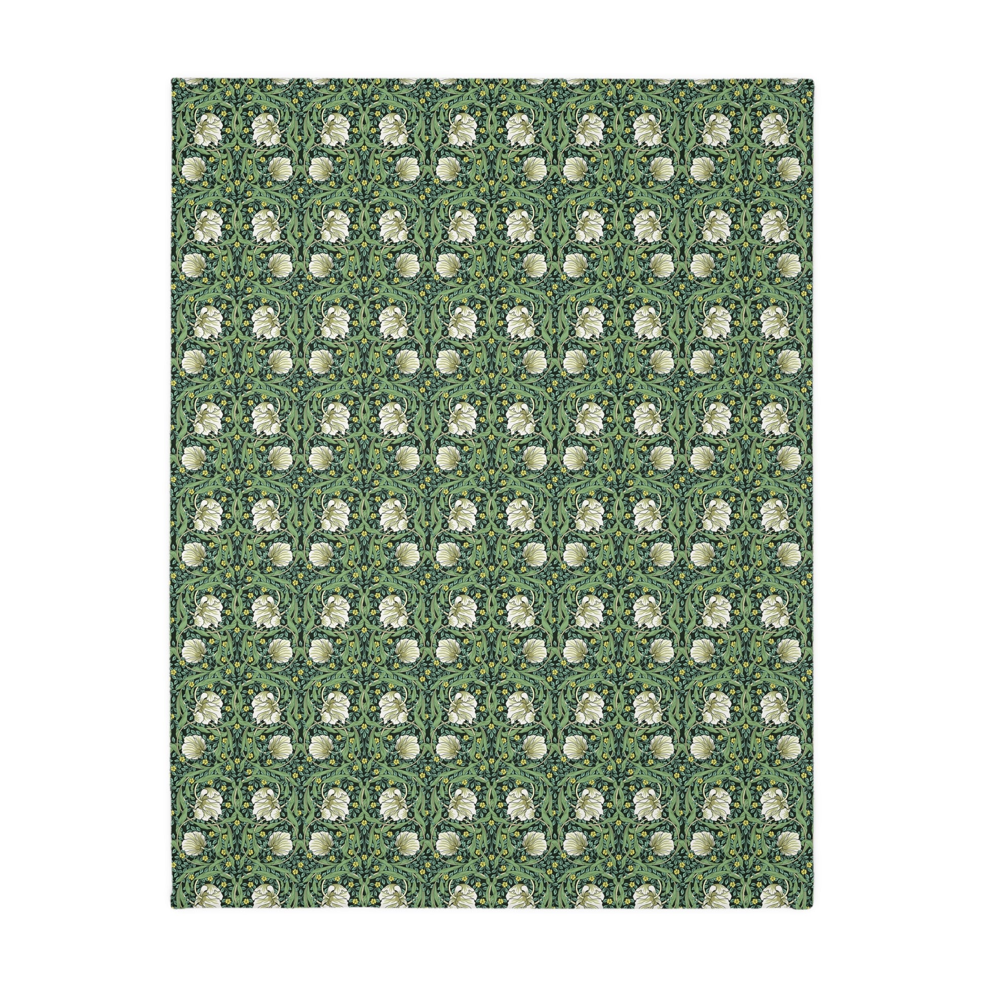 A rectangular blanket with a two-sided print featuring William Morris & Co floral patterns in shades of slate and green in a pattern called Pimpernel with a luxurious velveteen texture.