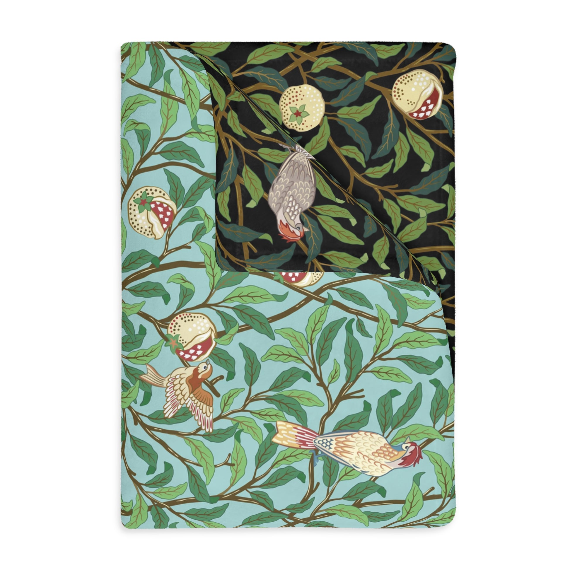 A rectangular blanket with a two-sided print featuring birds and pomegranate fruits on a green leafy background in shades of tiffany blue and onyx.