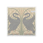 A square textile product, likely a napkin or small towel, featuring a vintage Art Nouveau design of two black swans facing each other in front of tall green reeds on a warm beige background.