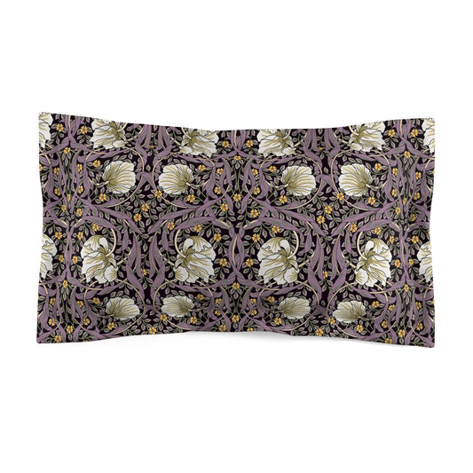 A pillow sham with a floral design inspired by William Morris, in cream, green, and purple colors, with a traditional decorative edging.