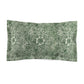 Pillow sham with a floral design inspired by William Morris in green and white colours on a king-sized bed.
