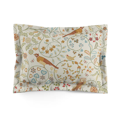 Decorative pillow with bird and floral pattern on a white background