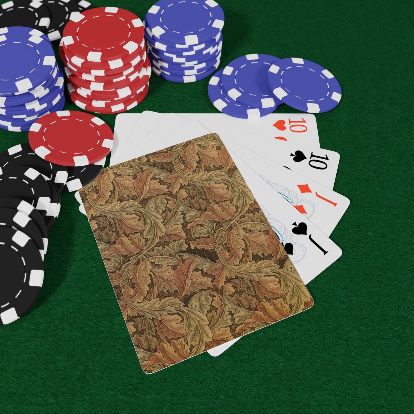 Poker chips and playing cards on a green felt surface