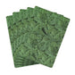 Set of green leaf-patterned placemats on a white background