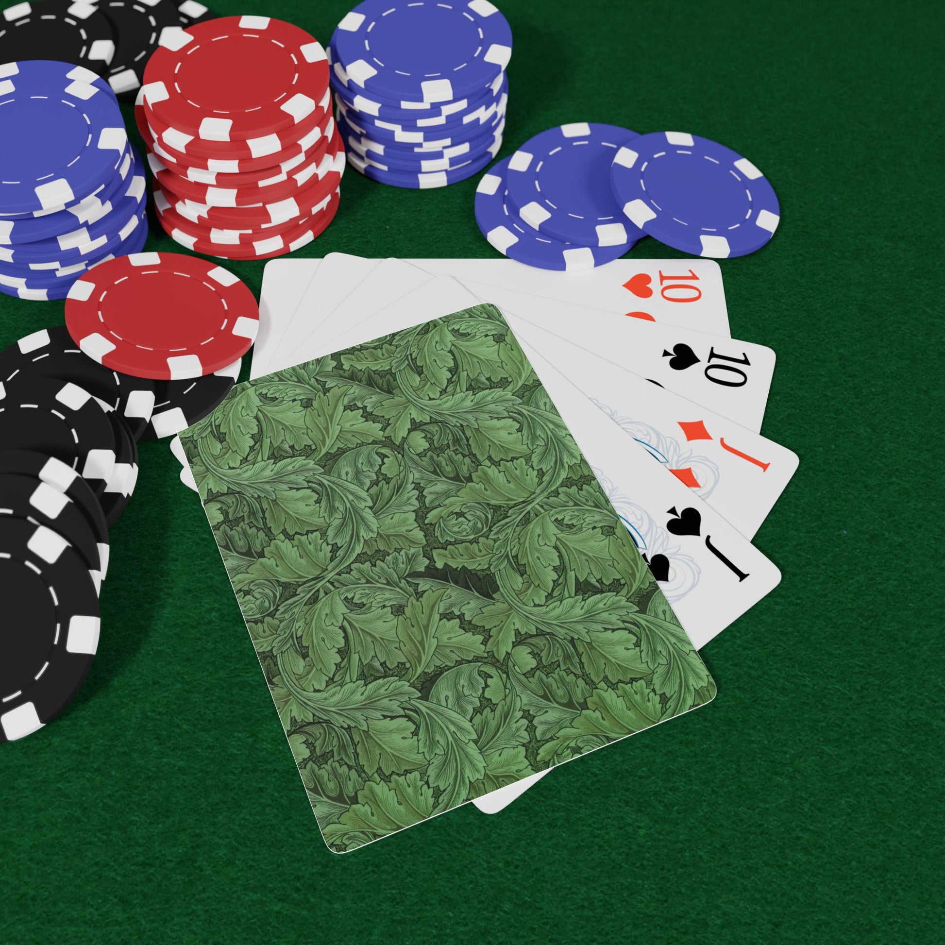 Poker chips and playing cards on a green felt surface