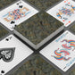 Playing cards with decorative designs on a dark surface