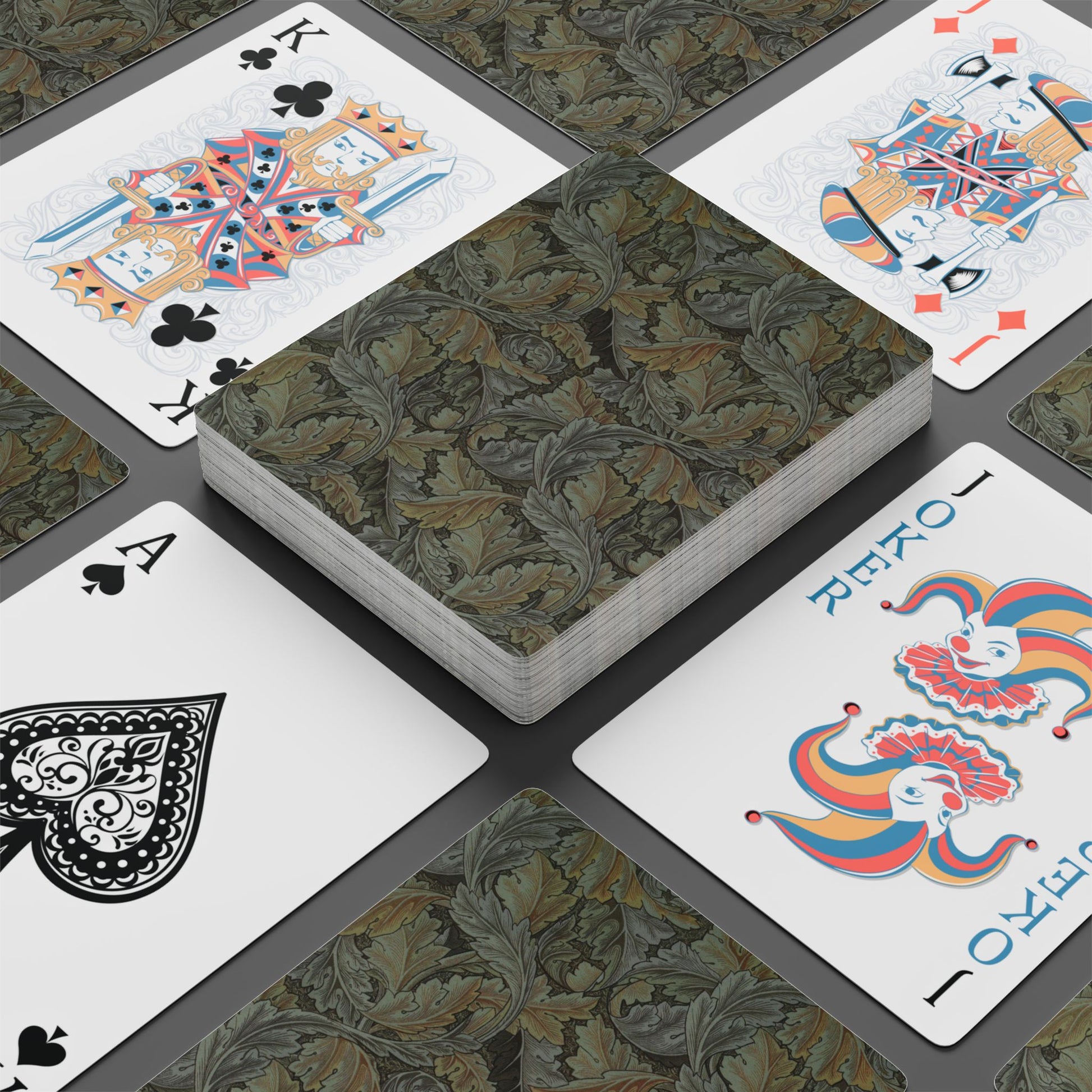 Playing cards with decorative designs on a dark surface