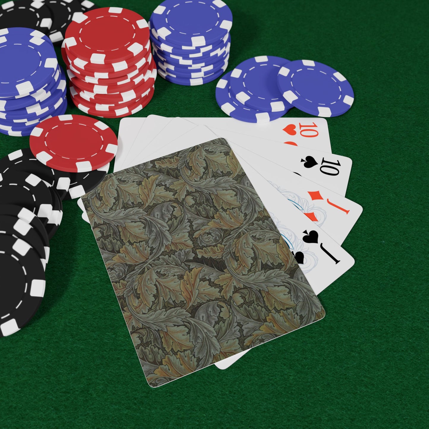 Poker chips and playing cards on a green felt surface